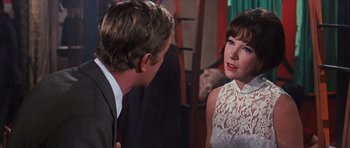 Movie still from “Gambit” (1966), directed by Ronald Neame – A man and a woman talking to each other; Close Up shot, Over the shoulder angle