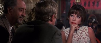 Movie still from “Gambit” (1966), directed by Ronald Neame – A man and a woman sitting at a dinner table; Close Up shot, Over the shoulder angle