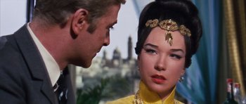 Movie still from “Gambit” (1966), directed by Ronald Neame – A man and a woman looking at one another; Close Up shot, Over the shoulder angle