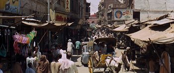 Movie still from “Gambit” (1966), directed by Ronald Neame – A busy street filled with lots of people and carts; Extreme Wide shot, High angle