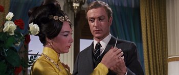 Movie still from “Gambit” (1966), directed by Ronald Neame – A man and a woman are looking at each other; Close Up shot, Over the shoulder angle