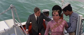 Movie still from “Gambit” (1966), directed by Ronald Neame – A man and a woman on a boat in the water; Medium shot, High angle