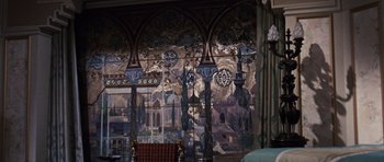 Movie still from “Gambit” (1966), directed by Ronald Neame – A room with a painting on the wall and a chair; Wide shot, High angle