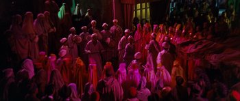 Movie still from “Gambit” (1966), directed by Ronald Neame – A group of people dressed up in costumes and hats; Extreme Wide shot, High angle