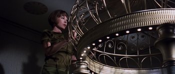 Movie still from “Gambit” (1966), directed by Ronald Neame – A woman standing in front of a metal cage; Medium shot, Low angle