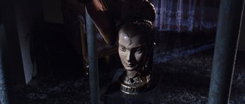 Movie still from “Gambit” (1966), directed by Ronald Neame – A statue of a woman's face being painted; Close Up shot, Over the shoulder angle