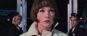Movie still from “Gambit” (1966), directed by Ronald Neame – A person with short brown hair; Close Up shot, Low angle