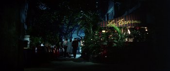 Movie still from “Game of Death” (1978), directed by Robert Clouse – A group of people walking down a sidewalk at night; Wide shot, High angle