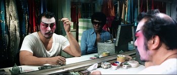Movie still from “Game of Death” (1978), directed by Robert Clouse – Two men sitting in front of a mirror; Medium shot, Over the shoulder angle