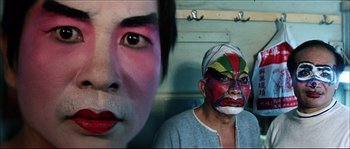 Movie still from “Game of Death” (1978), directed by Robert Clouse – Two people with face paint on their faces; Close Up shot, Low angle