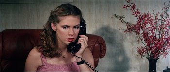 Movie still from “Game of Death” (1978), directed by Robert Clouse – A woman holding a phone up to her ear; Close Up shot, High angle