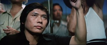 Movie still from “Game of Death” (1978), directed by Robert Clouse – A person sitting on a bus; Close Up shot, Low angle