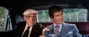 Movie still from “Game of Death” (1978), directed by Robert Clouse – Two older men in a car , one holding a cane; Close Up shot, High angle