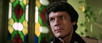 Movie still from “Game of Death” (1978), directed by Robert Clouse – A man with green eyes looking to his left; Close Up shot, Low angle