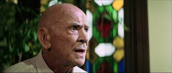 Movie still from “Game of Death” (1978), directed by Robert Clouse – An old man with a bald head looking up at the sky; Close Up shot, Low angle