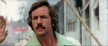 Movie still from “Game of Death” (1978), directed by Robert Clouse – A person with a mustache; Close Up shot, Low angle