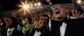 Movie still from “Game of Death” (1978), directed by Robert Clouse – A group of people sitting in front of an audience; Medium shot, Low angle