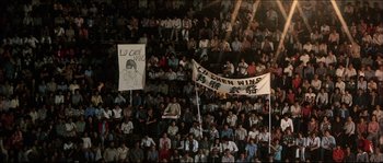 Movie still from “Game of Death” (1978), directed by Robert Clouse – A crowd of people sitting and standing in a stadium; Extreme Wide shot, High angle