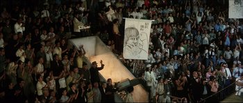 Movie still from “Game of Death” (1978), directed by Robert Clouse – A crowd of people watching a man on a skateboard; Extreme Wide shot, High angle