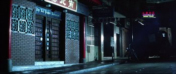 Movie still from “Game of Death” (1978), directed by Robert Clouse – A city street at night in the dark; Extreme Wide shot, Low angle