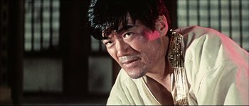 Movie still from “Game of Death” (1978), directed by Robert Clouse – A person with a beard; Close Up shot, Low angle