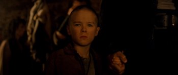 Movie still from “Gangs of New York” (2002), directed by Martin Scorsese – A young boy is looking into the camera; Close Up shot, Over the shoulder angle