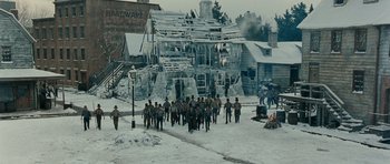 Movie still from “Gangs of New York” (2002), directed by Martin Scorsese – A group of people standing in front of a building; Extreme Wide shot, High angle
