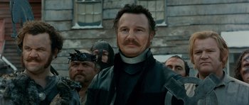 Movie still from “Gangs of New York” (2002), directed by Martin Scorsese – A group of men standing next to each other in front of a building; Close Up shot, Low angle