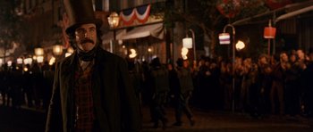 Movie still from “Gangs of New York” (2002), directed by Martin Scorsese – A crowd of people walking down a street at night; Medium shot, Over the shoulder angle