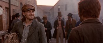 Movie still from “Gangs of New York” (2002), directed by Martin Scorsese – A group of men in old time clothing walking down a street; Medium shot, Over the shoulder angle