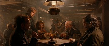 Movie still from “Gangs of New York” (2002), directed by Martin Scorsese – A group of people sitting around a table; Medium shot, Over the shoulder angle