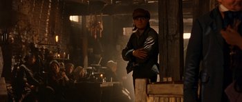 Movie still from “Gangs of New York” (2002), directed by Martin Scorsese – A man standing in front of a group of people in a room; Medium shot, Over the shoulder angle