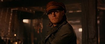 Movie still from “Gangs of New York” (2002), directed by Martin Scorsese – A man wearing a brown hat and a jacket; Close Up shot, Low angle