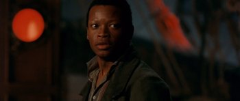 Movie still from “Gangs of New York” (2002), directed by Martin Scorsese – A person wearing a jacket and looking at the camera; Close Up shot, Over the shoulder angle