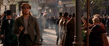 Movie still from “Gangs of New York” (2002), directed by Martin Scorsese – A group of men in top hats and coats walking down a street; Medium shot, Over the shoulder angle