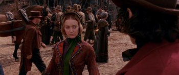 Movie still from “Gangs of New York” (2002), directed by Martin Scorsese – A woman in a colorful dress and a green hat; Close Up shot, Over the shoulder angle