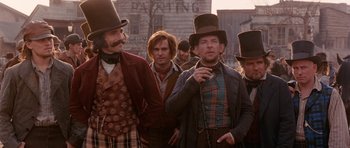 Movie still from “Gangs of New York” (2002), directed by Martin Scorsese – A group of men standing next to each other wearing hats; Medium shot, Low angle