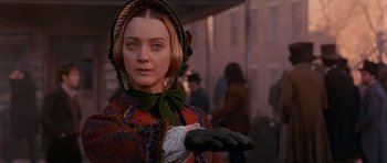Movie still from “Gangs of New York” (2002), directed by Martin Scorsese – A woman in a period dress holding a glove; Close Up shot, Over the shoulder angle