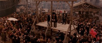 Movie still from “Gangs of New York” (2002), directed by Martin Scorsese – A group of men standing on top of a wooden platform; Wide shot, High angle