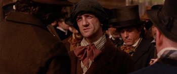Movie still from “Gangs of New York” (2002), directed by Martin Scorsese – A person wearing a suit and hat; Close Up shot, Low angle