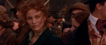 Movie still from “Gangs of New York” (2002), directed by Martin Scorsese – A person wearing a suit and hat; Close Up shot, Over the shoulder angle