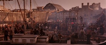 Movie still from “Gangs of New York” (2002), directed by Martin Scorsese – A group of people standing on top of a dock; Extreme Wide shot, High angle