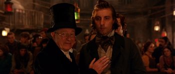 Movie still from “Gangs of New York” (2002), directed by Martin Scorsese – A man in a top hat and a man in a suit and bow tie; Close Up shot, Over the shoulder angle