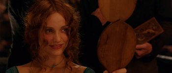 Movie still from “Gangs of New York” (2002), directed by Martin Scorsese – A beautiful young woman with red hair smiling; Close Up shot, Over the shoulder angle