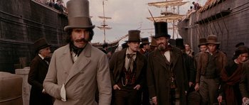 Movie still from “Gangs of New York” (2002), directed by Martin Scorsese – A group of men in top hats and suits; Medium shot, Low angle