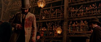Movie still from “Gangs of New York” (2002), directed by Martin Scorsese – A man in a costume standing in front of a crowd of people; Wide shot, Low angle