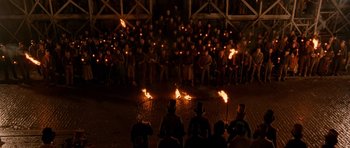 Movie still from “Gangs of New York” (2002), directed by Martin Scorsese – A group of people standing in front of a group of people holding torches; Extreme Wide shot, High angle