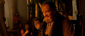 Movie still from “Gangs of New York” (2002), directed by Martin Scorsese – A man with a beard and a bow tie standing next to another man; Medium shot, Low angle