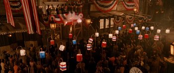 Movie still from “Gangs of New York” (2002), directed by Martin Scorsese – A crowd of people standing around a building; Extreme Wide shot, Overhead angle