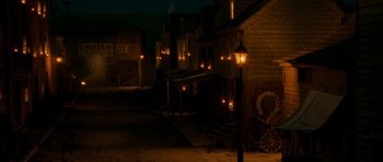 Movie still from “Gangs of New York” (2002), directed by Martin Scorsese – An old western town at night lit up by candles; Extreme Wide shot, High angle